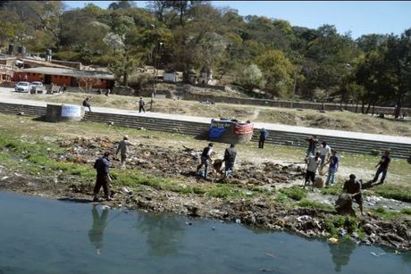 Volunteers spread along the Bagmati banks clearing debris at Pashupati Aryaghat