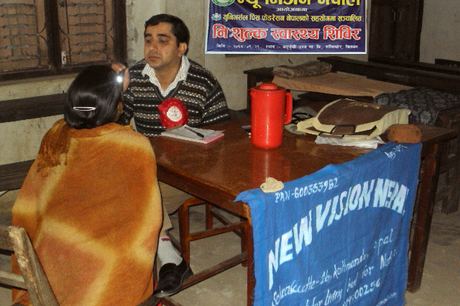 A health worker examining a patient at the free health camp for the Chepang community, Shaktikhor