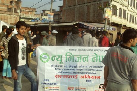 Volunteers with the New Vision Nepal cleanliness-campaign banner