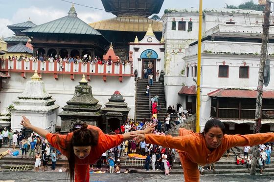 A group practising yoga together in the courtyard at Pashupatinath