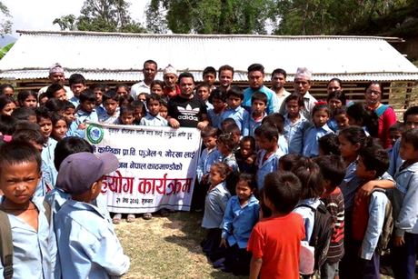 Pupils, teachers and volunteers gathered outside Kalika Primary School