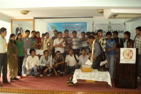 Participants and guests gathered on a stage under New Vision Nepal banners