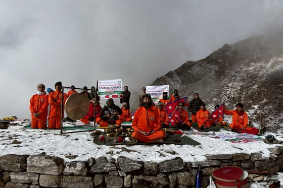 Members of a retreat group gathered on high ground around singing bowls and a gong